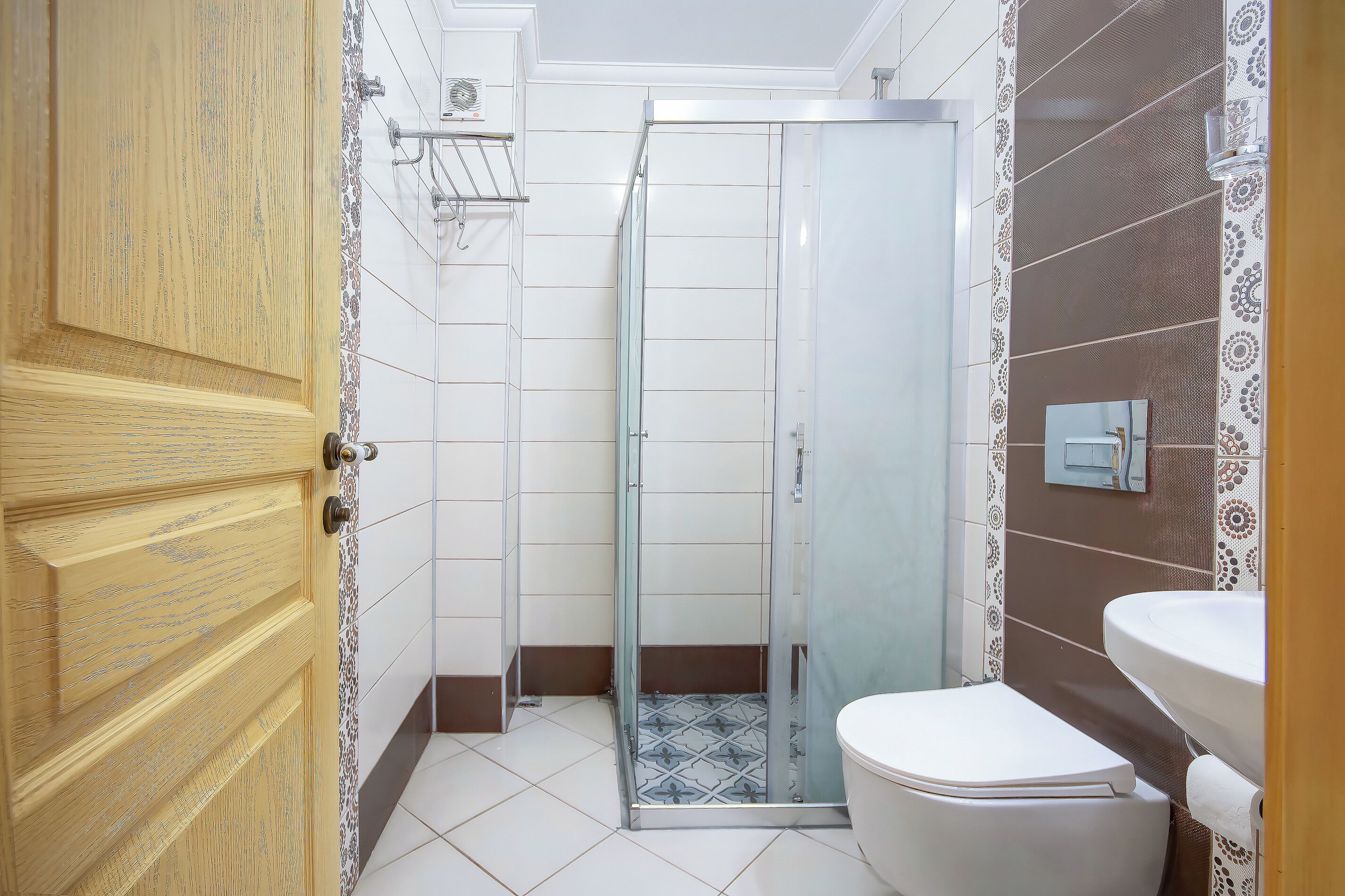 A bathroom with a shower, toilet, and sink.
