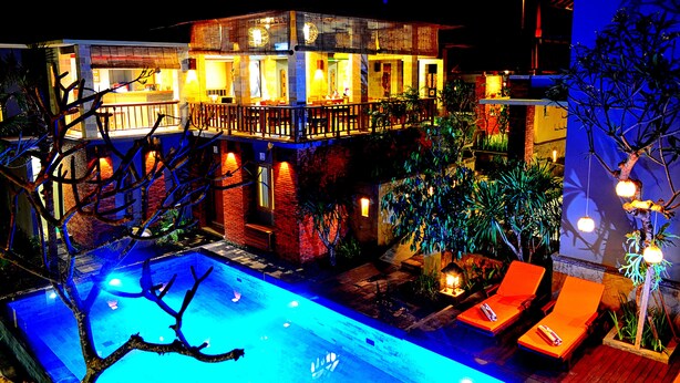 A two-story building with a swimming pool, outdoor seating, and well-lit surroundings. - Tetirah Boutique Hotel Ubud (Ubud)