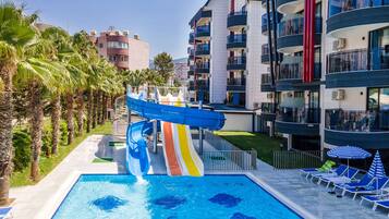 Relax by the pool with lounge chairs and umbrellas, or enjoy the water slide for a fun day.