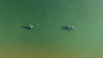 Two kayaks on a calm body of water.