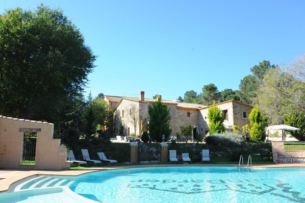 Outdoor pool, open 9:00 AM to 8:00 PM, pool umbrellas, pool loungers