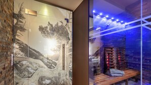 Un moderno espacio de spa con pared de vidrio, banco de madera y pared de piedra con estantes.
