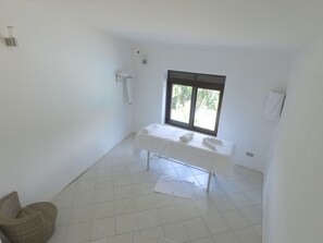 A clean, white bathroom with a bench, a window, and a towel rack. - Trackers Safari Lodge Bwindi (Bwindi)