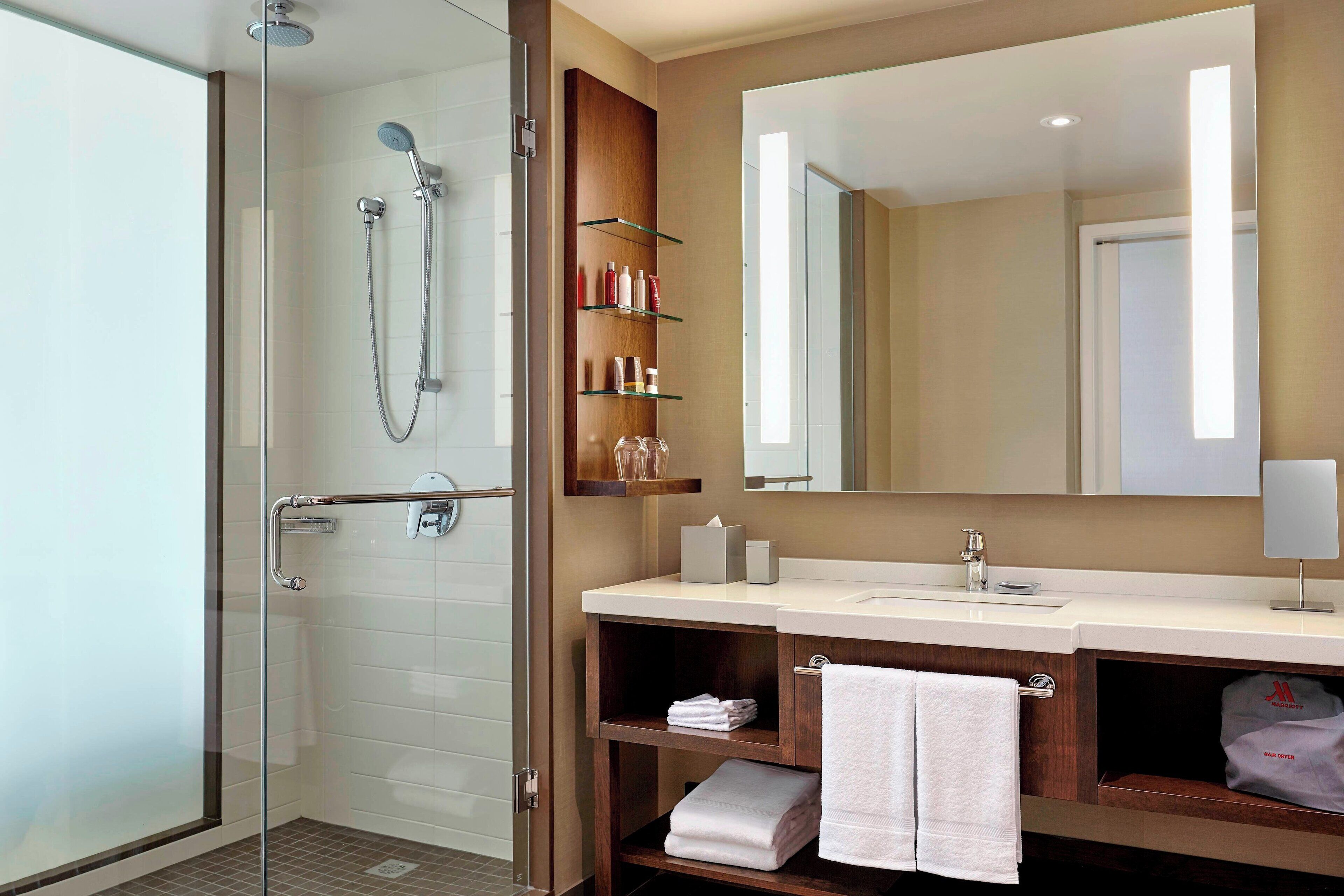 designer toiletries, hair dryer, towels