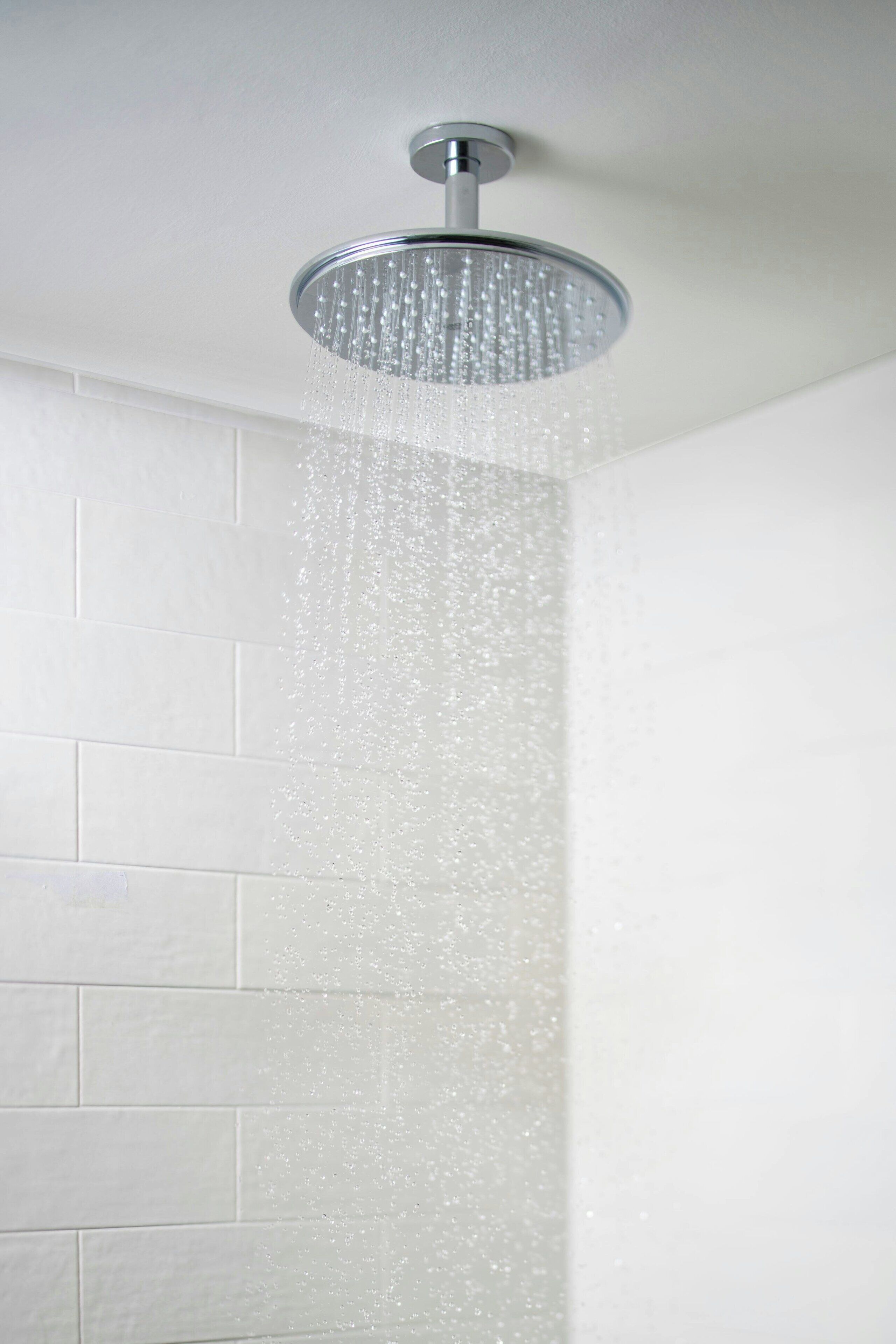A modern showerhead with water flowing down.