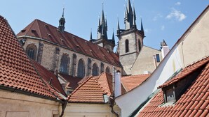 A historic building with a red-tiled roof and multiple spires. - Cathedral Prague Apartments (Prague)