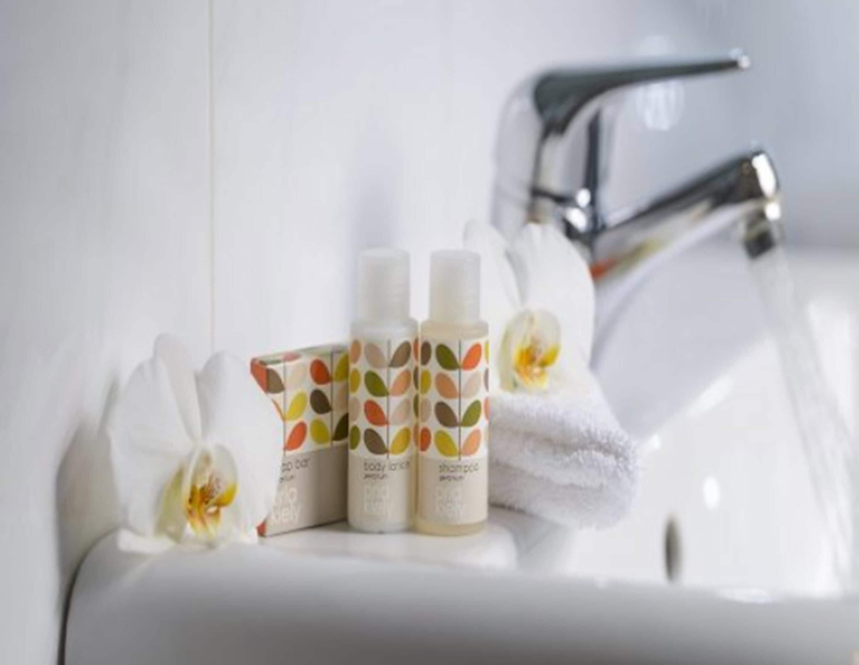 designer toiletries, hair dryer, towels