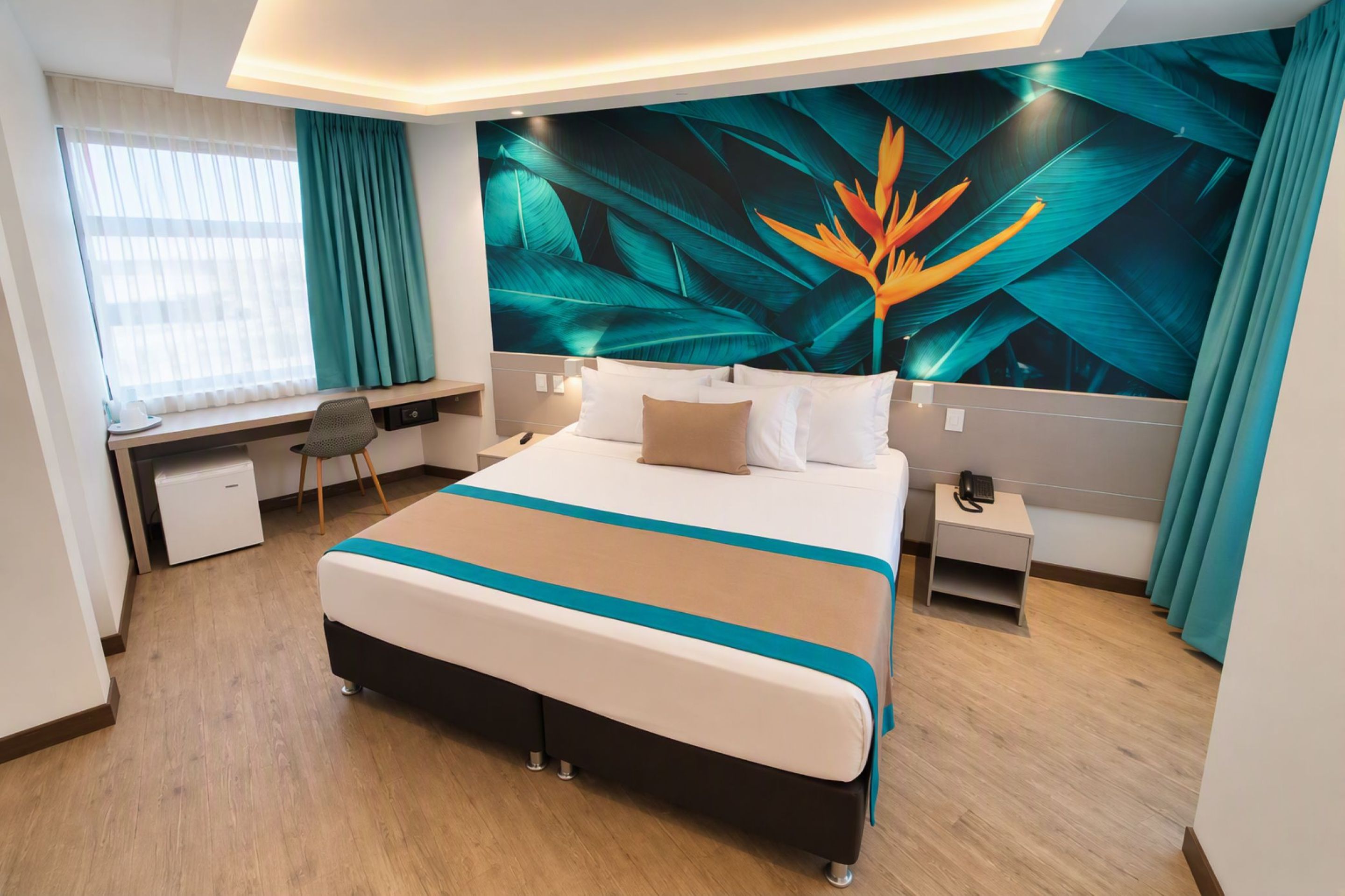 A hotel room with a large bed, a desk, a chair, a nightstand, and a wall with a tropical leaf and flower mural.