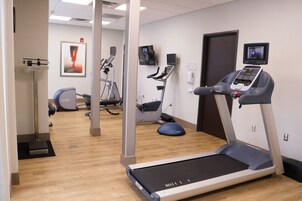 A fitness center with treadmills, stationary bikes, and a rowing machine.