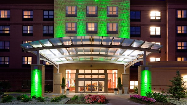 A Holiday Inn hotel with a modern facade, large glass entrance, and a well-lit exterior. - Holiday Inn Jonesboro by IHG (Jonesboro)