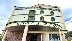 A building with a sign reading "HOTEL CASTLE VILLAGE." - Hotel Castle Village Miyakojima (Miyakojima)
