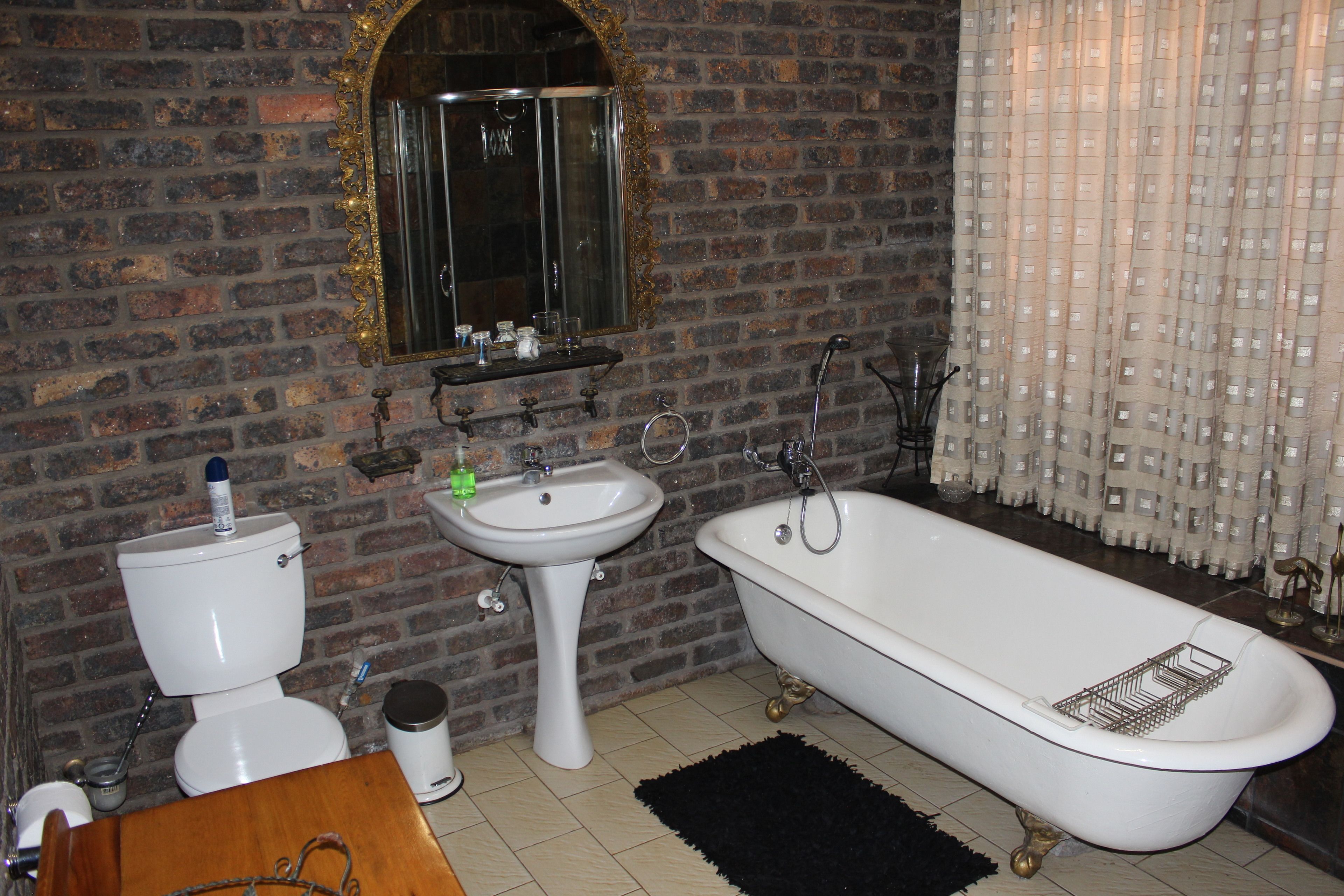 A bathroom with a toilet, sink, and bathtub.