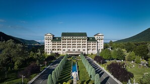 A large, multi-story hotel with a symmetrical facade, central courtyard, and a fountain. - Qafqaz Riverside Resort Hotel (Gabala)
