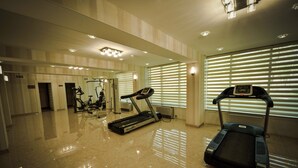 A gym with treadmills, exercise bikes, and a mirrored wall. -  Qebele Yeddı Gozel Hotel (Gabala)