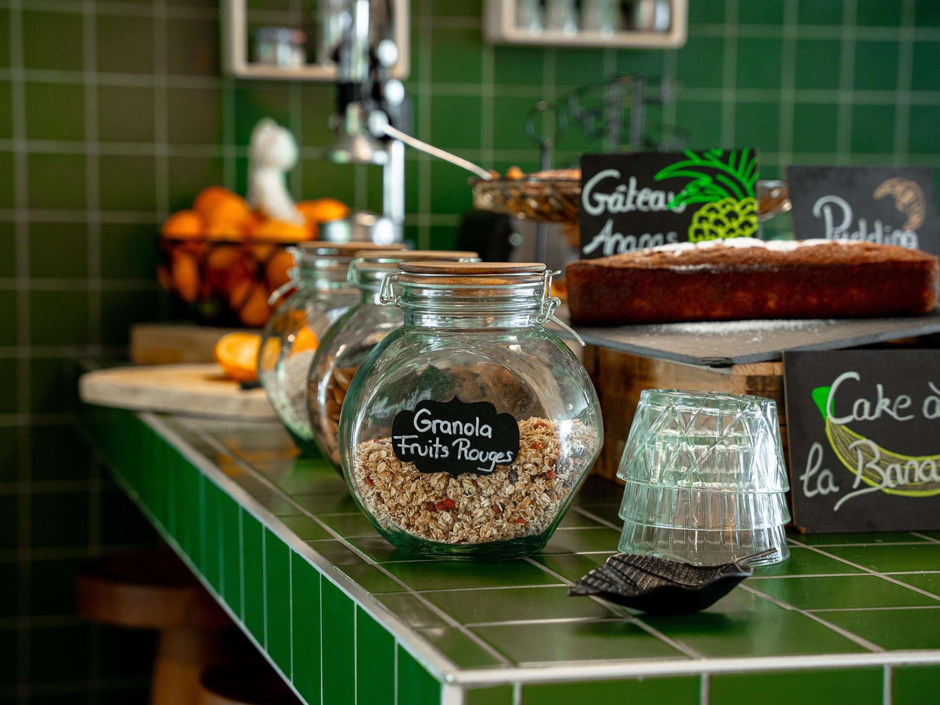 Un buffet pour le petit-déjeuner proposant des céréales, des yaourts aux fruits et des gâteaux, ainsi qu’une décoration à base d’ananas.