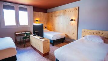 Habitación de hotel con dos camas, un escritorio, una silla y un televisor.
