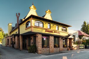 A yellow building with a sign that reads 'Pension Zoborská'.