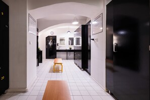 A hallway with lockers, a bench, and a clock on the wall. - Penzión & Wellness Zoborská (Nitra)