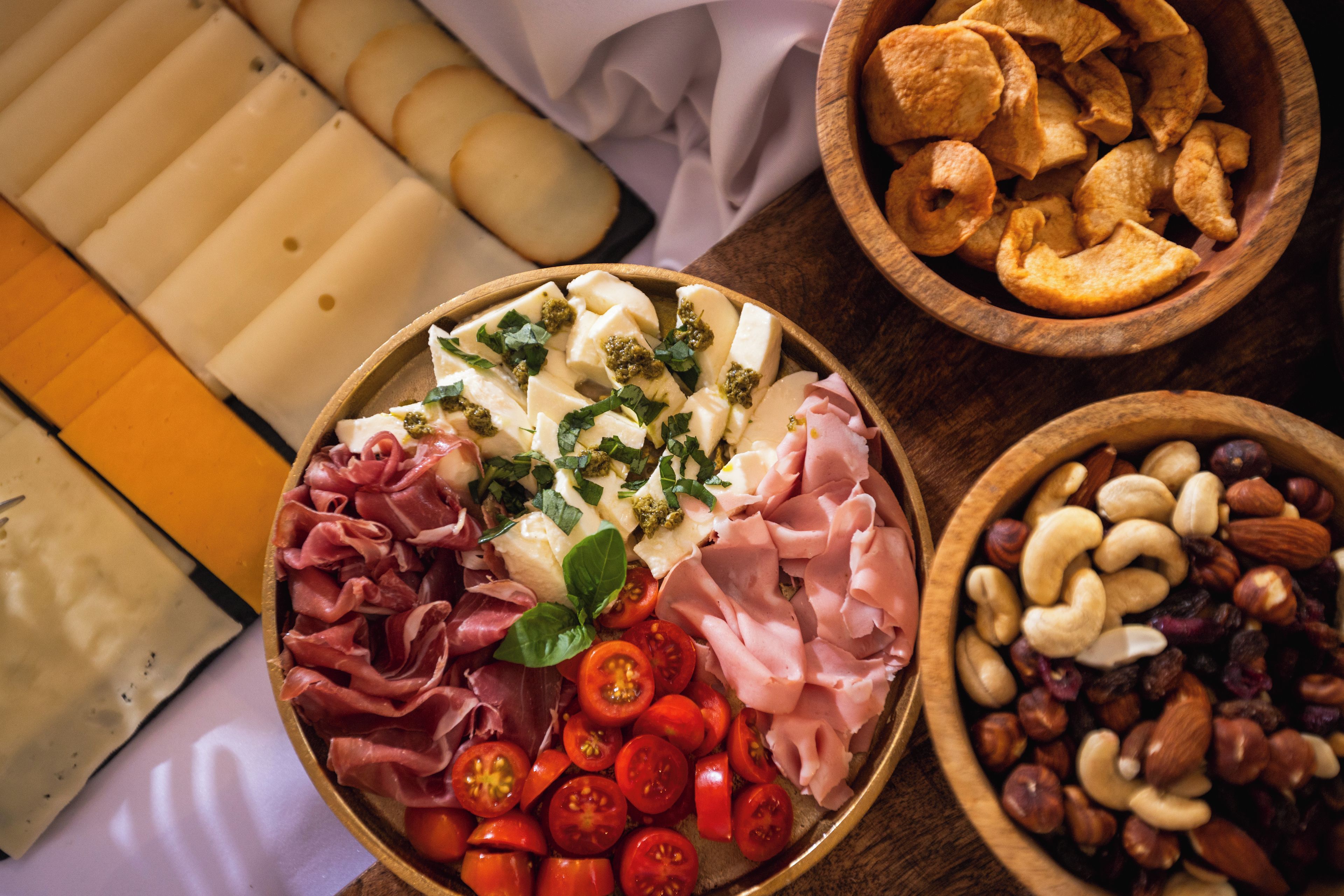 A charcuterie board with various meats, cheeses, and accompaniments.