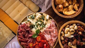 A charcuterie board with various meats, cheeses, and accompaniments.