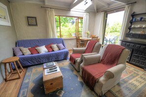 Standard Cabin, 1 Bedroom, Garden View, Garden Area | Living room | 3-inch flat-screen TV with satellite channels, TV, fireplace - Maple Grove (Nkonkobe)