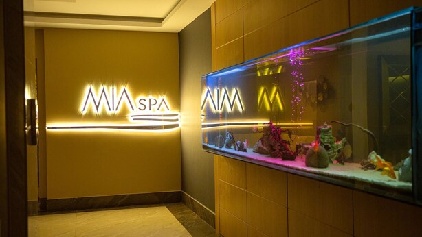 A hotel lobby with a neon sign reading "MIA SPA" and a decorative aquarium on the right. - Premier Vista Hotel Silivri (Silivri)