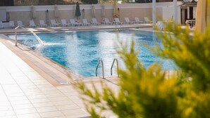 A swimming pool with white lounge chairs and a tiled deck. - Premier Vista Hotel Silivri (Silivri)