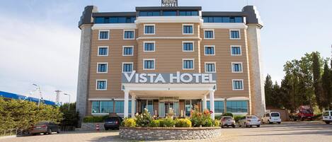 A multi-story hotel with a prominent "VISTA HOTEL" sign.