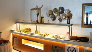 A buffet area with a variety of food items, a sign indicating 'Premier Vista Hotel', and decorative wall art. - Premier Vista Hotel Silivri (Silivri)