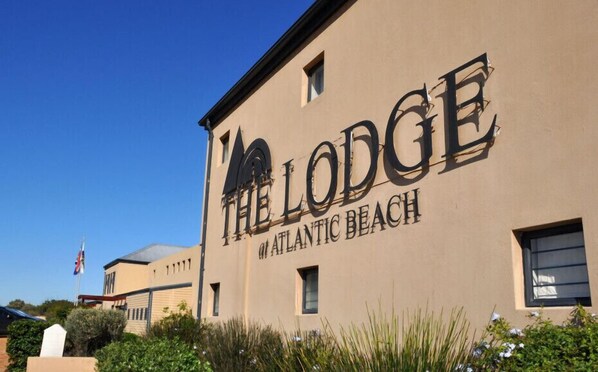 A building with the sign 'THE LODGE AT ATLANTIC BEACH'.