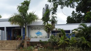 A building with a sign reading "Turtle Bay Lodge" and a reception area visible. - Turtle Bay Lodge (St. Lucia)