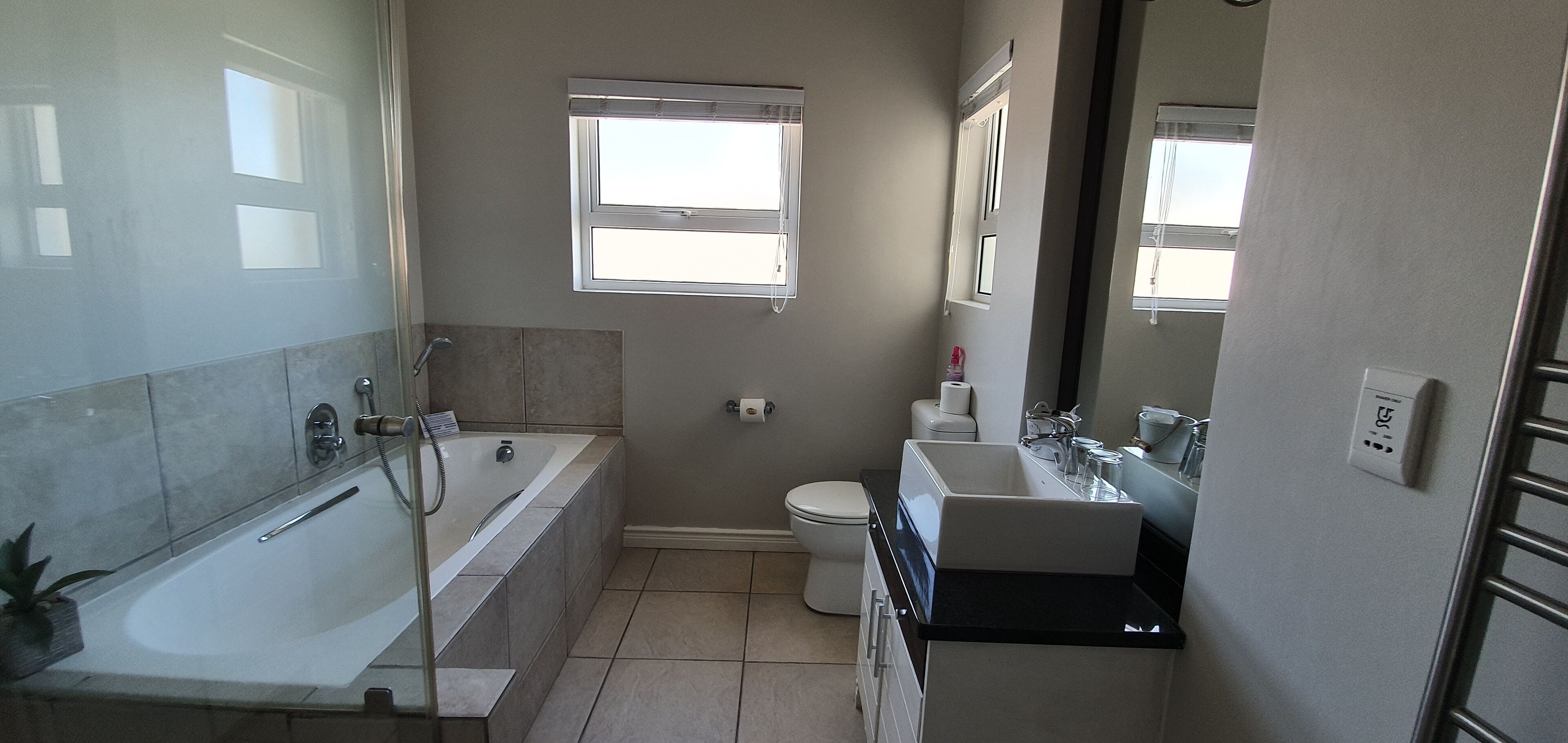 A bathroom with a bathtub, toilet, and sink.