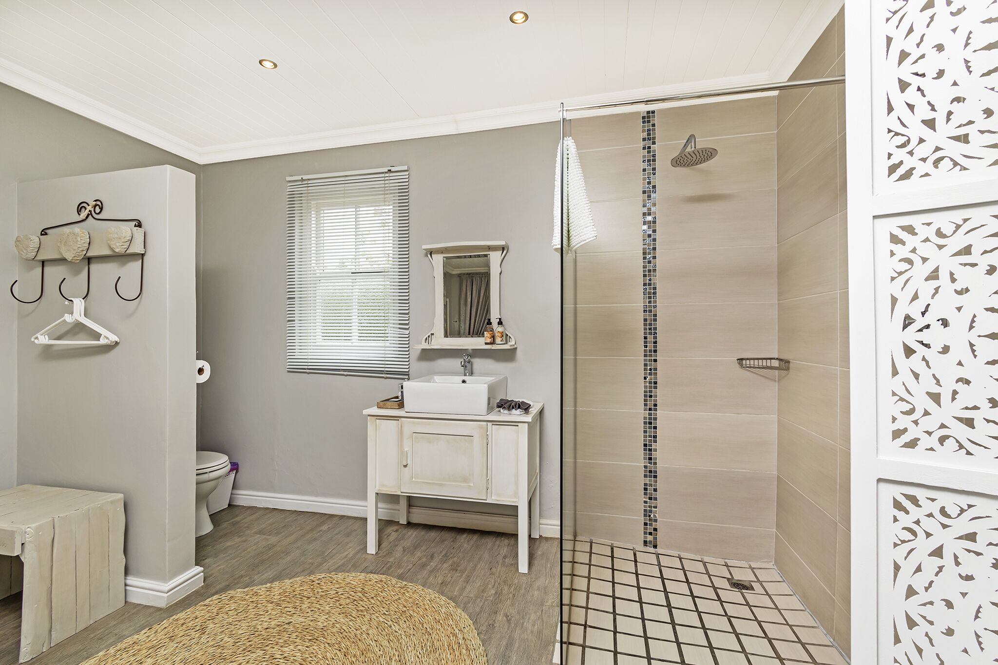 Une salle de bain équipée d’une douche, de toilettes, d’un lavabo et d’un porte-serviettes mural.
