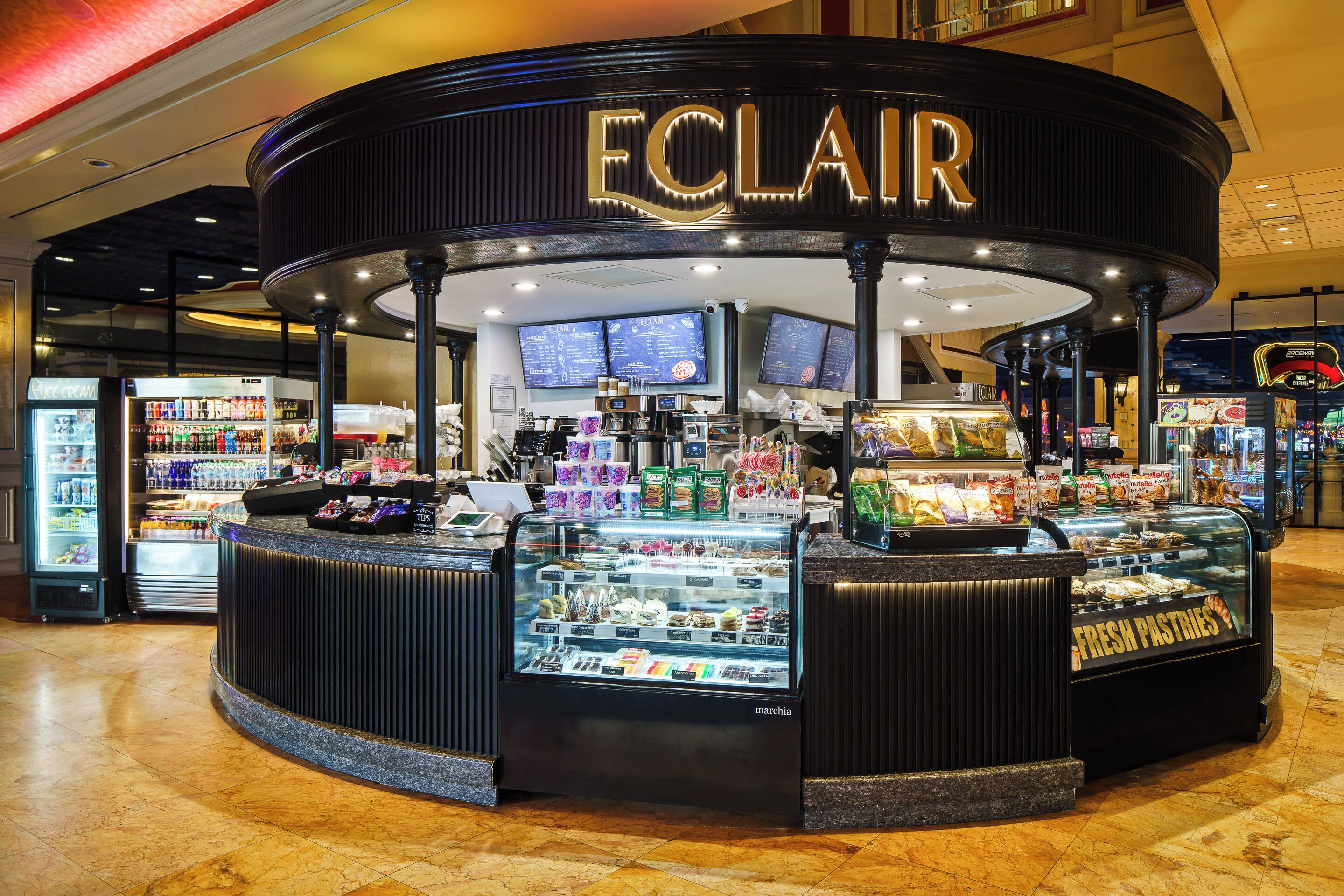 A bakery named ECLAIR with a display case of pastries and a refrigerated section.