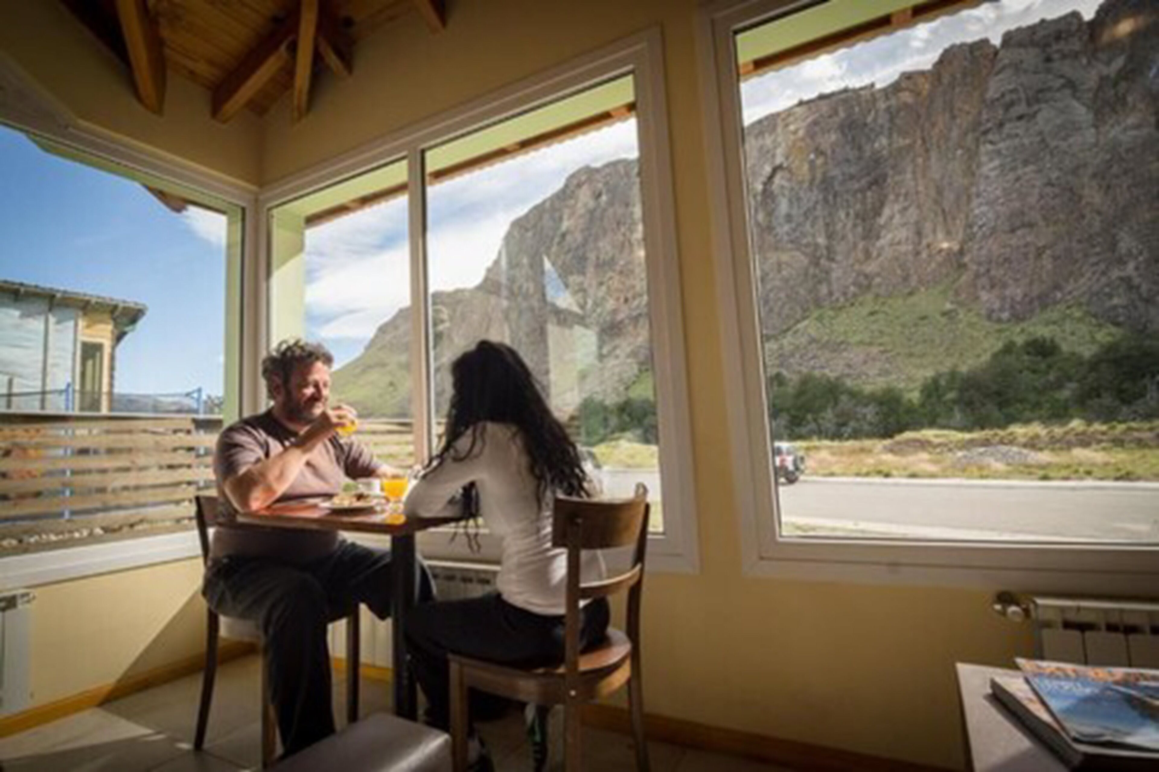 Una habitación con amplios ventanales que ofrecen vistas a un paisaje montañoso.