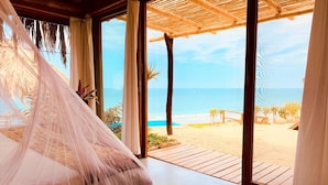 A room with a bed, large windows, and a view of the beach. - La Playa (Los Organos)