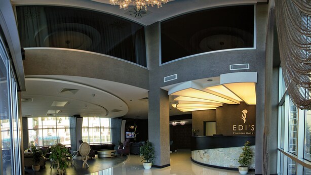 A spacious hotel lobby with a modern chandelier, seating areas, and a reception desk. - Edis Premier Hotel (Adana)