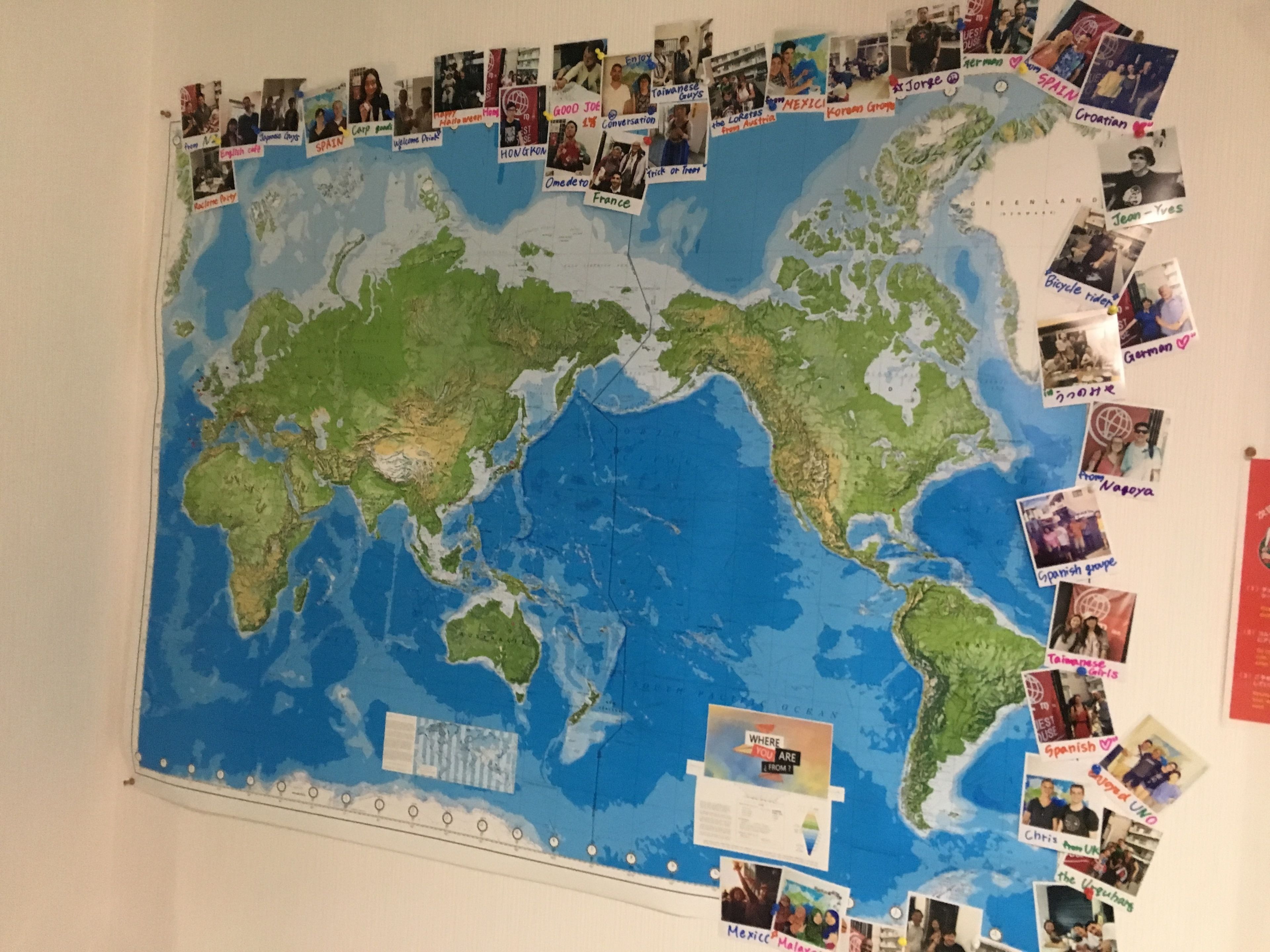 A world map with photos pinned to various countries, indicating travel experiences.