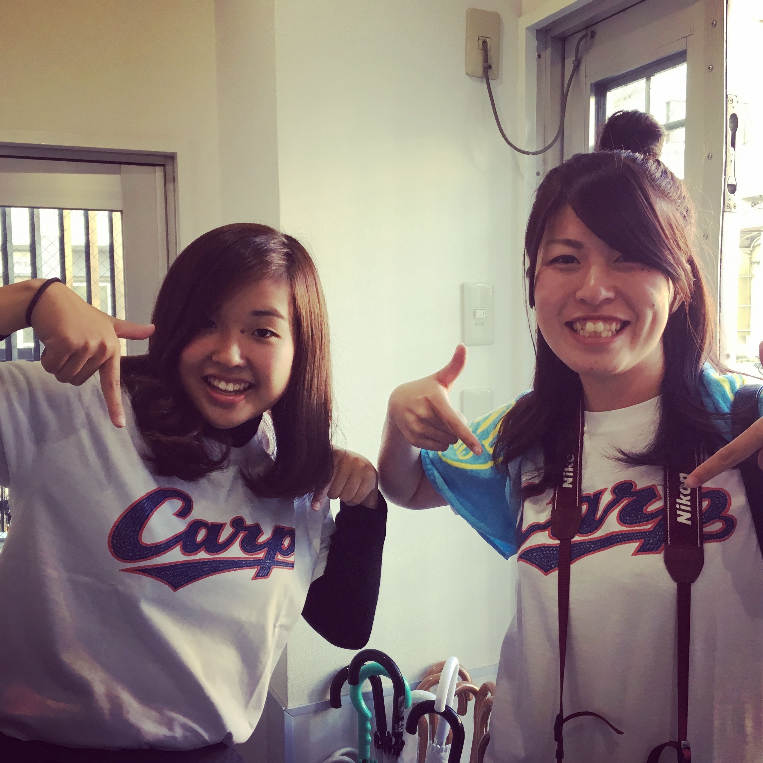 Two people wearing matching 'Carp' t-shirts pointing at something.