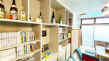 A library with bookshelves, a table, and a sofa.