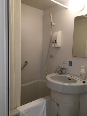 A bathroom with a sink, mirror, towel rack, shower, and hand dryer. - Idaimae Green Hotel (Saga)