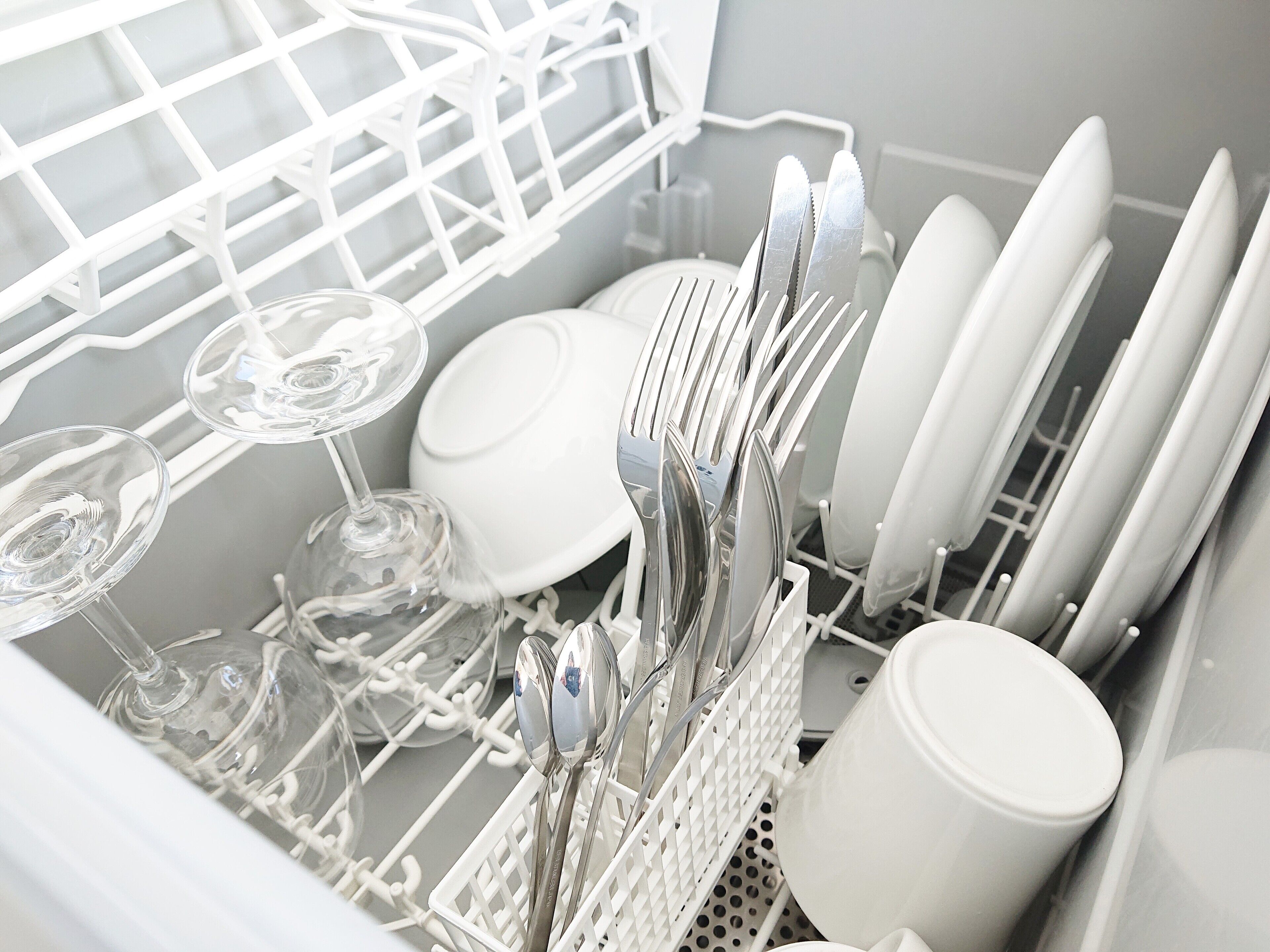 A dishwasher filled with various dishes and glasses.