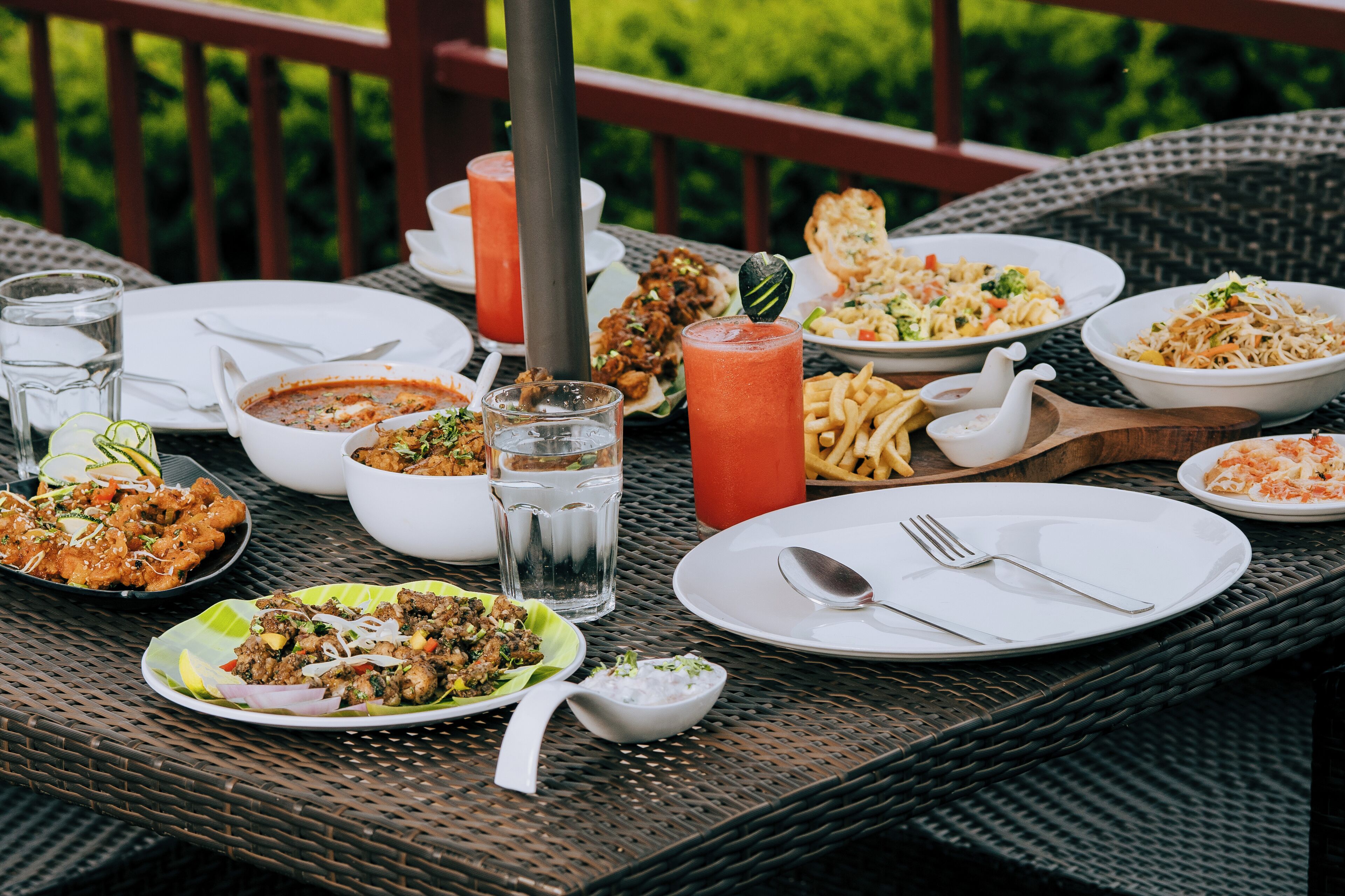 A dining table with various dishes, glasses, and utensils.