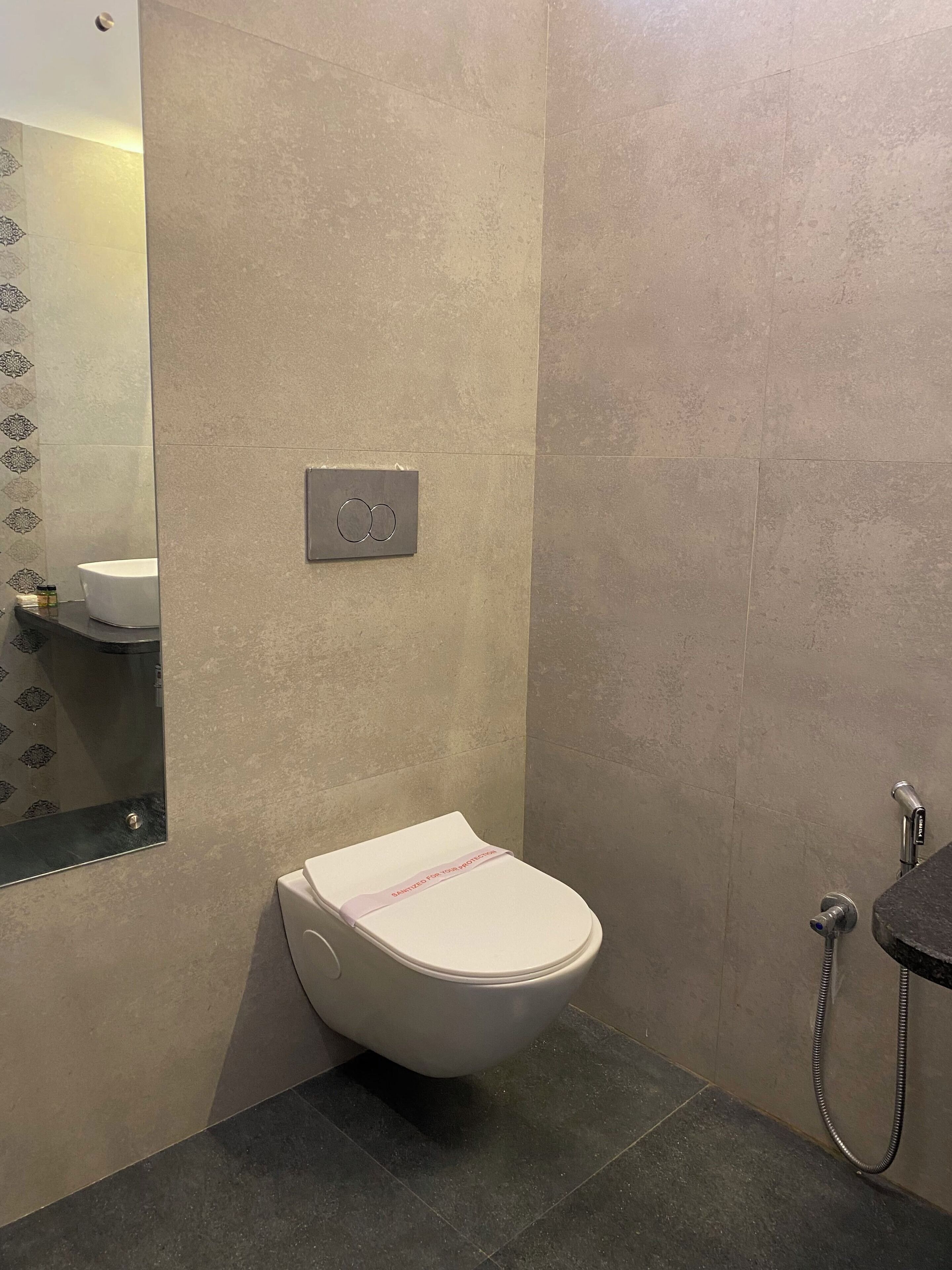 A bathroom with a toilet, a sink, and a shower.