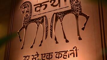 A wall with a decorative emblem featuring two horses and text in a non-Latin script.