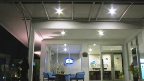 A hotel entrance with a reception desk, seating area, and a sign for 'Cen Hotel'. - Cengkareng Transit Hotel (Tangerang)