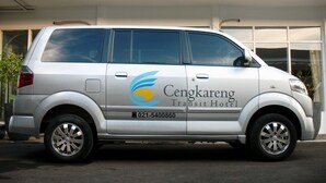 A white van with "Cengkareng Transit Hotel" branding and a contact number. - Cengkareng Transit Hotel (Tangerang)