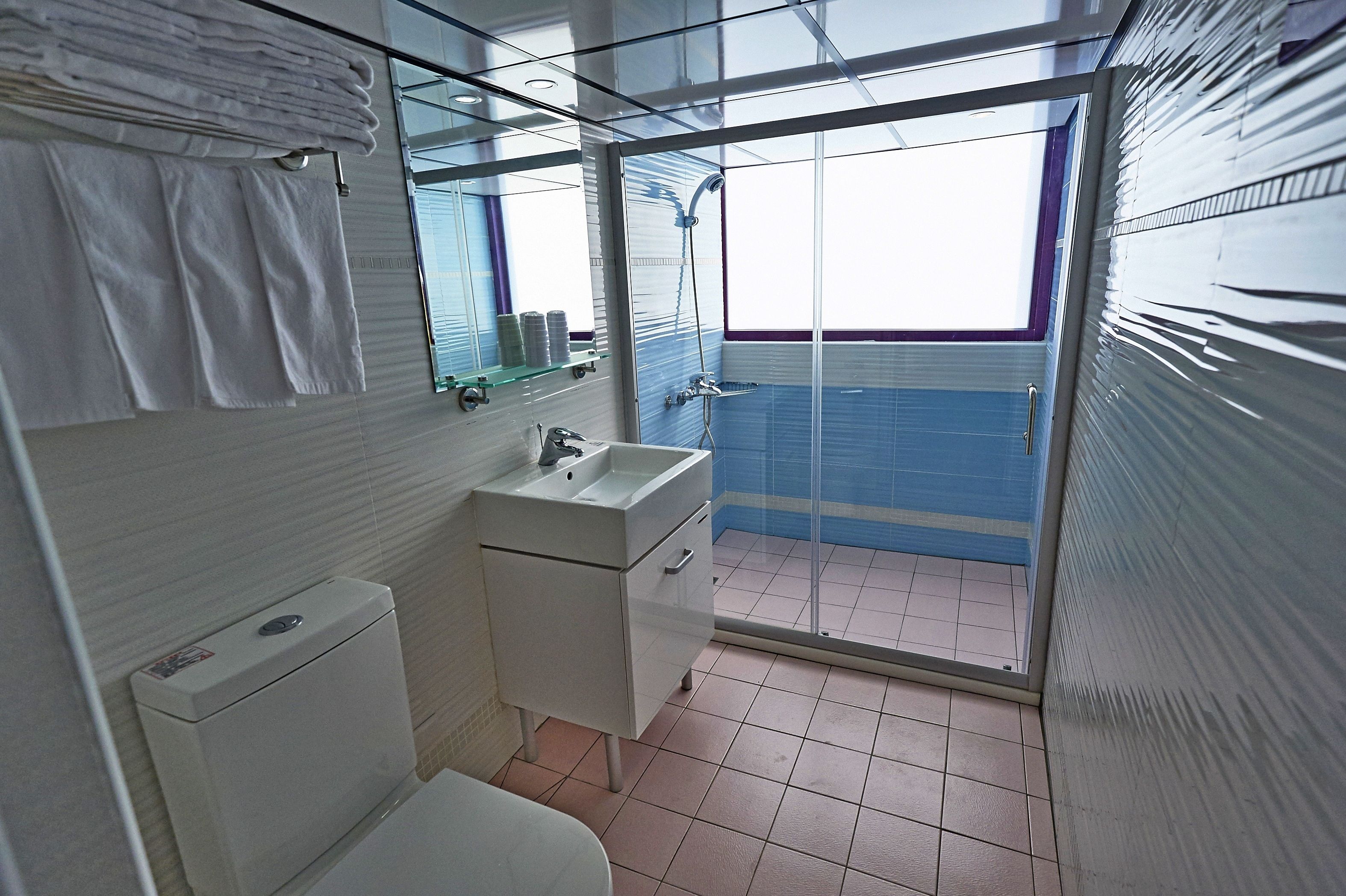 family room | bathroom | shower, rainfall showerhead, hair dryer, slippers