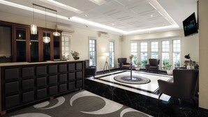 A modern lobby with a reception desk, seating area, and large windows. - Grand Tebu Hotel (Bandung)