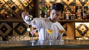 A bartender pouring a drink into a martini glass. - Gracious Bagan Hotel (Nyaung-U)
